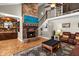 Two story Gathering room with a large brick fireplace and comfortable seating at 2083 Biltmore Pt, Longwood, FL 32779