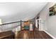 Loft overlooking living area with wood flooring and railing at 2083 Biltmore Pt, Longwood, FL 32779