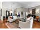 Bright living room with hardwood floors, comfortable seating and grand piano at 2083 Biltmore Pt, Longwood, FL 32779