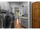 Bright laundry room with gray cabinets, LG washer and dryer at 2083 Biltmore Pt, Longwood, FL 32779