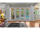 Living room with French doors opening to a pool and patio area at 2083 Biltmore Pt, Longwood, FL 32779