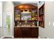 Custom wet bar with wine storage and granite countertop at 2083 Biltmore Pt, Longwood, FL 32779