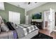 Guest bedroom with TV and access to bathroom at 2083 Biltmore Pt, Longwood, FL 32779