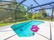 Refreshing pool with screened enclosure at 605 Oakpoint Cir, Davenport, FL 33837