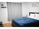 Cozy bedroom with a queen-size bed and gray curtains at 605 Oakpoint Cir, Davenport, FL 33837