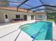 Inviting pool area with screened enclosure and patio furniture at 605 Oakpoint Cir, Davenport, FL 33837