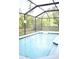 Relaxing screened-in pool with a floating device at 605 Oakpoint Cir, Davenport, FL 33837