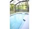 Screened-in pool with floating device at 605 Oakpoint Cir, Davenport, FL 33837