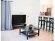 Living room with TV, coffee table, and kitchen view at 605 Oakpoint Cir, Davenport, FL 33837