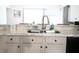 Kitchen features a double sink and light cabinets at 605 Oakpoint Cir, Davenport, FL 33837