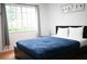 Bedroom with a queen bed and large window, providing natural light at 605 Oakpoint Cir, Davenport, FL 33837