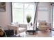Living room with comfy seating and large windows at 605 Oakpoint Cir, Davenport, FL 33837