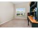 Home office with large window, built-in shelving, and a wooden desk at 400 Harbor Winds Ct, Winter Springs, FL 32708
