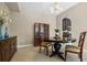 Bright dining room features a round table with four chairs, a china cabinet, and tile floors at 400 Harbor Winds Ct, Winter Springs, FL 32708