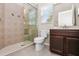 Bathroom with shower, toilet, and vanity with wood cabinets at 400 Harbor Winds Ct, Winter Springs, FL 32708