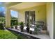 Covered patio with potted plants and a bench at 400 Harbor Winds Ct, Winter Springs, FL 32708