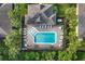 Community pool with surrounding lounge chairs and palm trees at 400 Harbor Winds Ct, Winter Springs, FL 32708
