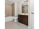 Bathroom with tub, toilet and dark brown vanity at 400 Harbor Winds Ct, Winter Springs, FL 32708