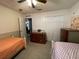 A bedroom with two twin beds, dresser, and ceiling fan at 185 Winding Cove Ave, Apopka, FL 32703