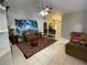 Living room with tile floors, comfortable furniture, and large wall art at 185 Winding Cove Ave, Apopka, FL 32703