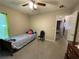 A small bedroom with a twin bed, chair, and access to another room at 185 Winding Cove Ave, Apopka, FL 32703