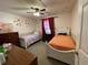 A bedroom with two twin beds, dressers, and sunflower wall decor at 185 Winding Cove Ave, Apopka, FL 32703