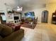 Living room with tile floors, comfortable furniture, and large wall art at 185 Winding Cove Ave, Apopka, FL 32703