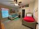 A bedroom with two twin beds, Disney-themed decor and ceiling fan at 185 Winding Cove Ave, Apopka, FL 32703