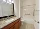 Bathroom with granite countertop vanity and shower/tub combo at 2108 Shantiniketan Blvd # B8, Tavares, FL 32778