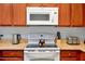 Close up of kitchen countertop with stove and microwave at 3174 Feltrim Pl # 104, Kissimmee, FL 34747