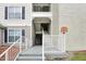Exterior view of condo building with a staircase and ramp at 3174 Feltrim Pl # 104, Kissimmee, FL 34747