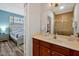 Clean bathroom with a vanity, shower, and view into bedroom at 3174 Feltrim Pl # 104, Kissimmee, FL 34747