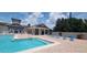 Community pool with lounge chairs and covered seating area at 3174 Feltrim Pl # 104, Kissimmee, FL 34747