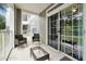 Private patio with two wicker chairs and a small table at 3174 Feltrim Pl # 104, Kissimmee, FL 34747