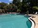 Community pool with surrounding lounge chairs at 4099 Dijon Dr # 4099H, Orlando, FL 32808