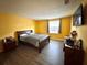 Main bedroom with large bed and wood-look flooring at 4099 Dijon Dr # 4099H, Orlando, FL 32808