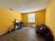 Bright yellow bedroom with window and wood-look flooring at 4099 Dijon Dr # 4099H, Orlando, FL 32808