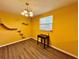 Bright yellow dining room with cat shelves and wood flooring at 4099 Dijon Dr # 4099H, Orlando, FL 32808