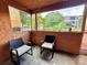 Screened-in patio with two chairs and view of trees at 4099 Dijon Dr # 4099H, Orlando, FL 32808
