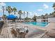 Community pool with lounge chairs and a blue canopy at 1930 Conway Rd # 6, Orlando, FL 32812