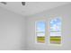 Bedroom with two windows offering a view of the landscape at 197 Valencia Ridge Dr, Auburndale, FL 33823