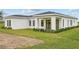 Back exterior view of house showcasing a covered patio at 197 Valencia Ridge Dr, Auburndale, FL 33823