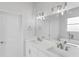 Elegant bathroom with double vanity, quartz countertop, and large mirror at 197 Valencia Ridge Dr, Auburndale, FL 33823
