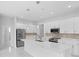 Modern kitchen with white cabinets, stainless steel appliances, and an island at 197 Valencia Ridge Dr, Auburndale, FL 33823