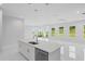 Modern kitchen with white cabinets, quartz countertops, and stainless steel appliances at 197 Valencia Ridge Dr, Auburndale, FL 33823