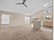 Open living room and kitchen area with vaulted ceilings and neutral colors at 2977 Kokomo Loop, Haines City, FL 33844