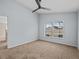 Bright bedroom with pool view and ceiling fan at 2977 Kokomo Loop, Haines City, FL 33844