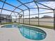 Relaxing kidney-shaped pool with screened patio at 2977 Kokomo Loop, Haines City, FL 33844