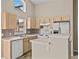Kitchen with light wood cabinets, stainless steel appliances, and a breakfast bar at 2977 Kokomo Loop, Haines City, FL 33844