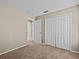 Bedroom with double door closet and access to hallway at 2977 Kokomo Loop, Haines City, FL 33844